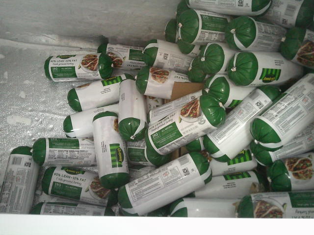 Tube-shaped rolls of ground turkey in a freezer.